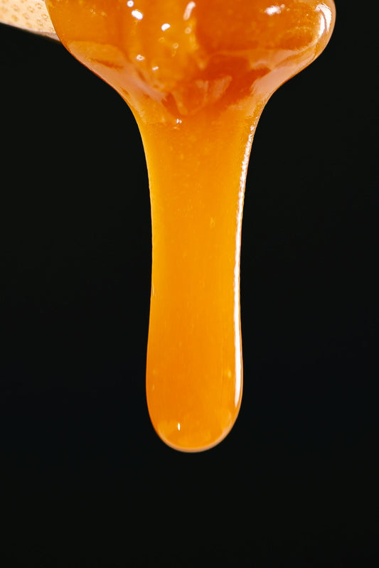 honey dipping spoon. Manuka honey overflowing